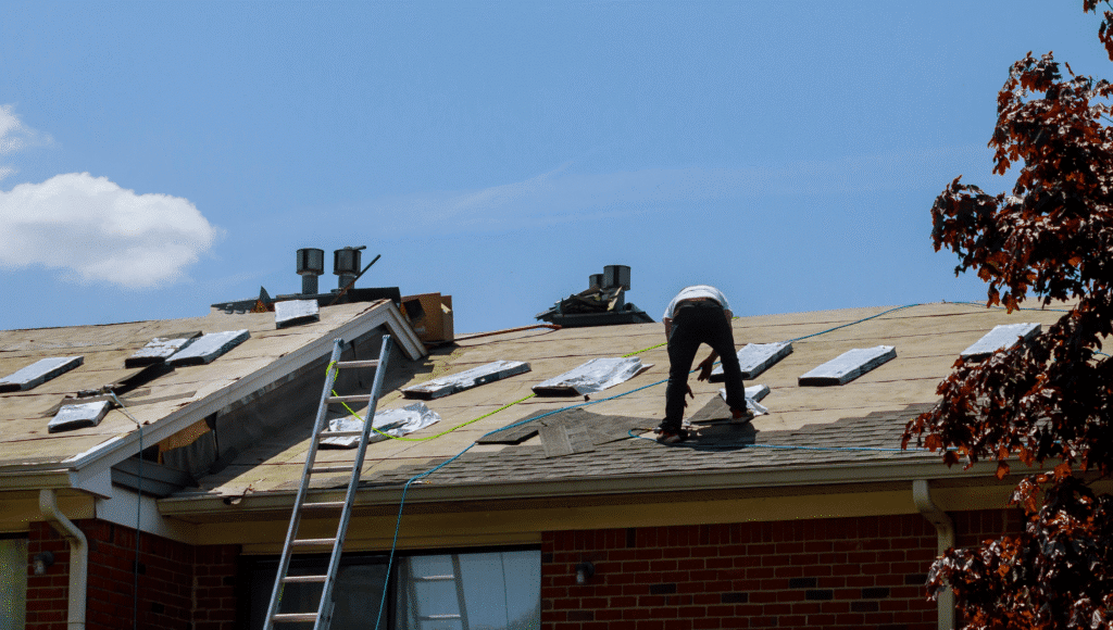 A Pilot Roofing team member repairing a Michigan roof that was damaged by hail