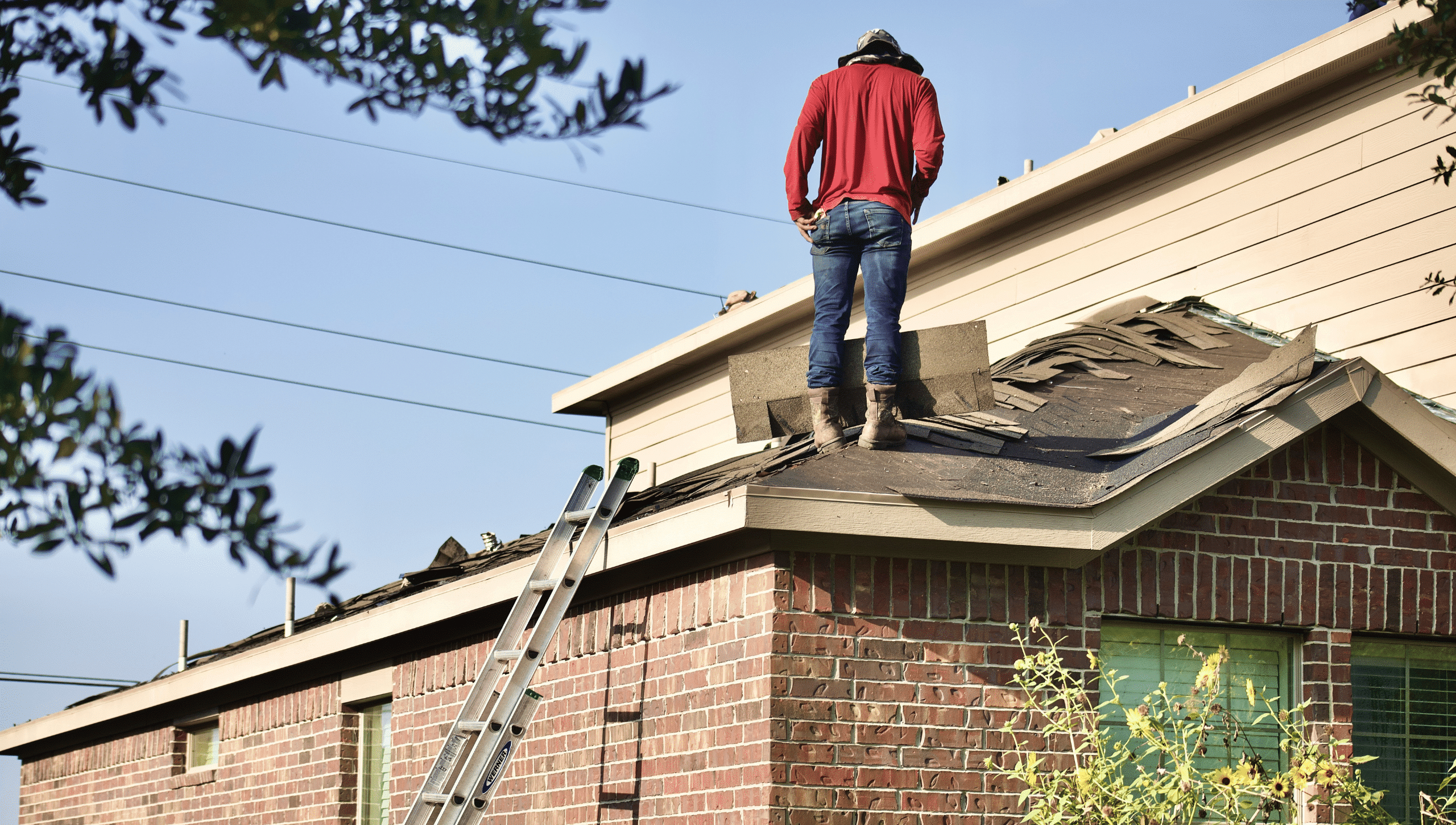 Pilot Roofing team member inspecting a damaged roof in Michigan